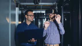 Male engineer controls his colleague's experience in virtual glasses from a computer - Powered by Shutterstock - Get 15% off with code: PIKWIZARD15