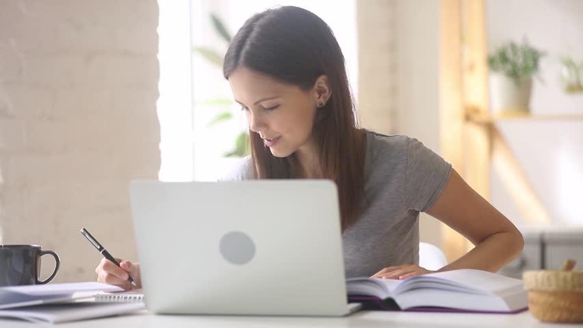 Teen girl student study online check homework with internet teacher talk by webcam looking at laptop, teenager make video call learning foreign language on computer, distant education,  Royalty-Free Stock Footage #1025576930