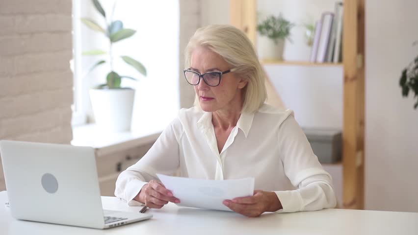 Stressed shocked angry old businesswoman annoyed about computer problem crumpling throwing paper on stuck laptop leaving office workplace quit job feel unable to work frustrated hate negative emotion Royalty-Free Stock Footage #1025576933
