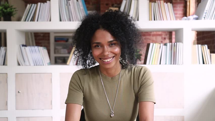 Smiling african american young woman student online teacher looking at camera webcam making video call to distant friend or job interview, happy mixed race blogger talking at webcamera recording vlog Royalty-Free Stock Footage #1025576942