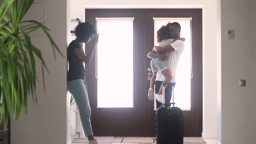 African dad talking to sad child daughter in hallway leaving family home with goodbye hug, black father embracing consoling kid say bye to upset little girl, parents divorce, shared custody concept | Shutterstock HD Video #1025577047