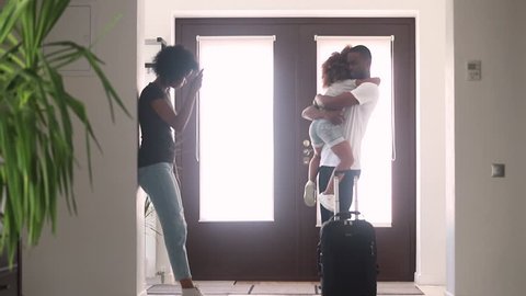 African dad talking to sad child daughter in hallway leaving family home with goodbye hug, black father embracing consoling kid say bye to upset little girl, parents divorce, shared custody concept