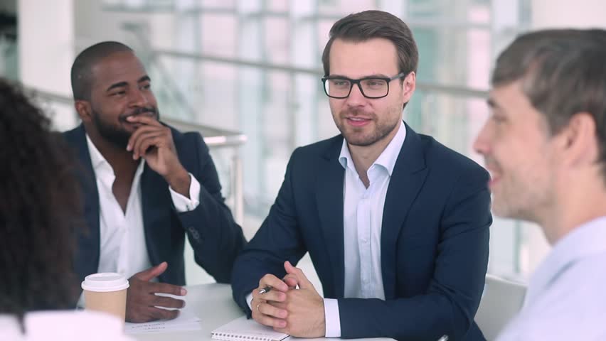 Satisfied caucasian boss hr negotiator talking shake hand of african american candidate partner client making deal, hiring or thanking for collaboration at diverse group business meeting negotiations Royalty-Free Stock Footage #1025577056