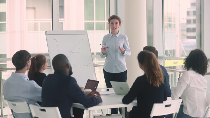 Diverse employees and female coach mentor raise hands at corporate business training workshop get engaged involved in voting volunteer participate in team office presentation support unanimous idea Royalty-Free Stock Footage #1025577065
