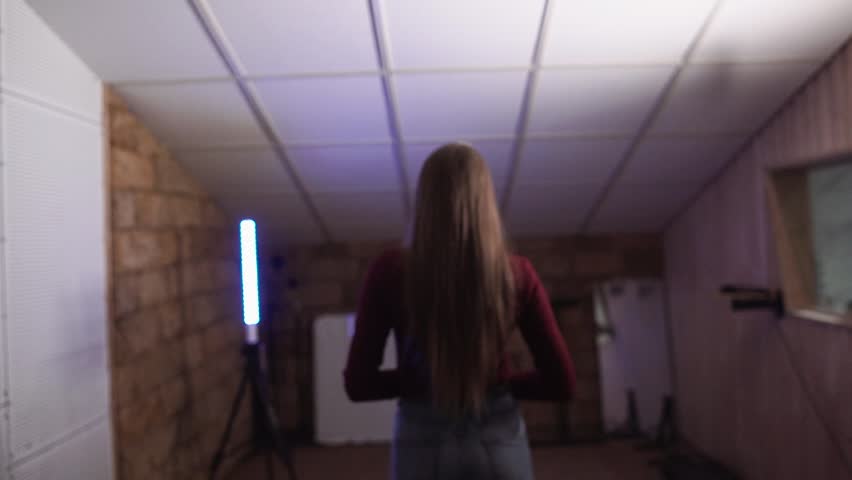 beautiful girl singing in a recording studio