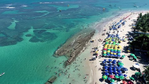 Aerial view of Porto de Galinhas Beach, Pernambuco, Brazil: unique experience of swimming with fishs in natural pools. Fantastic vacation travel. Candles, sailboats, rafts, boats in the harbor! 