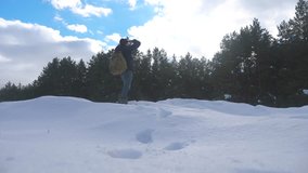 human feet go in deep snow winter. slow motion video. man traveler with backpack walks lifestyle in the snow forest winter. overcoming difficulties concept problems difficult path to success concept
