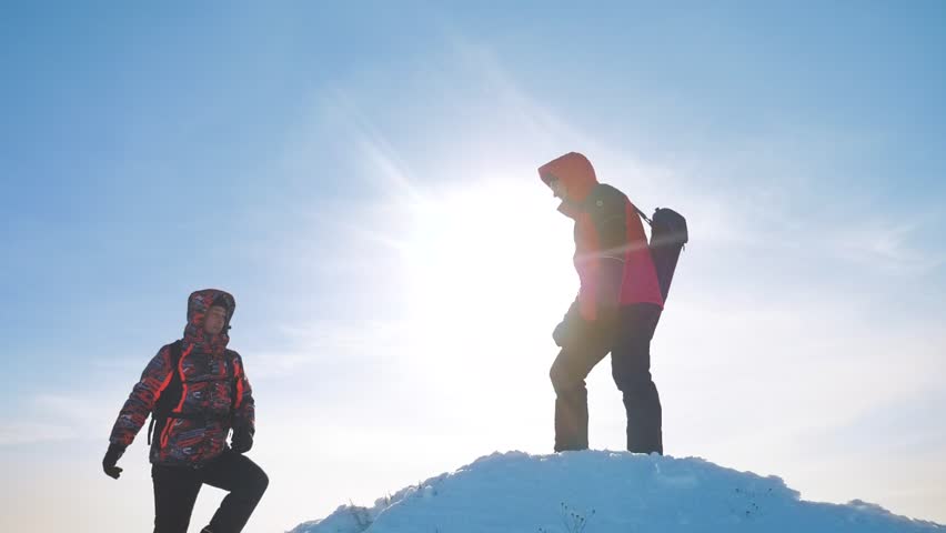 teamwork business concept victory help hands arm slow motion video. team group tourist hikers gives a helping hand. success win winter reached the top of the mountain. tourists climbers climb to the Royalty-Free Stock Footage #1025595425