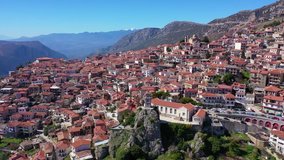 Aerial drone video from famous and picturesque village of Arachova built on the slope of Parnassus mountain with traditional character at spring, Voiotia, Greece