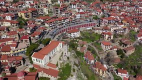 Aerial drone video from famous and picturesque village of Arachova built on the slope of Parnassus mountain with traditional character at spring, Voiotia, Greece