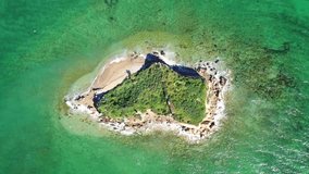 Aerial drone video of tropical paradise emerald sea islet in mediterranean destination