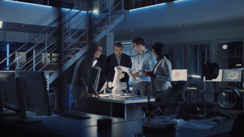 Team of Electronics Development Engineers Standing at the Desk Working on Robot Arm Prototype. Specialists Working on Ultra Modern Industrial Design, Using Machine Learning. Shot on 8K RED Camera | Shutterstock HD Video #1025609624