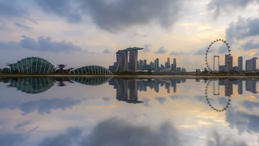 Beautiful Time lapse of Day to Night of Singapore city Marina Bay Sands CBD skyline by a river at dusk with reflection. Royalty-Free Stock Footage #1025611469