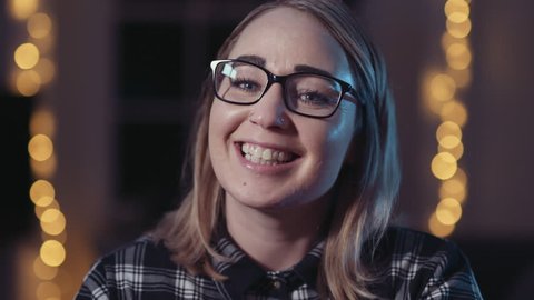 Nerdy blonde girl smiling, wearing glasses
