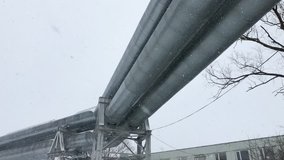 4K Huge gas pipeline laid along snowy street in Riga, Latvia