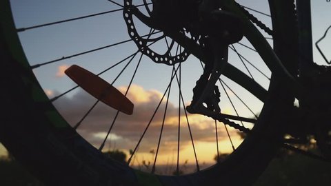 Spinning Bicycle wheel at sunset