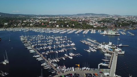 Drone shot of Oslo, Norway, Yacht and sailboats moored at the quay. Aerial 4k cinematic helicopter view. Top view harbor