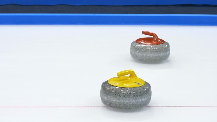 Curling stone hits another stone