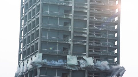 Skyscraper demolition blast. Building collapsing in real time.