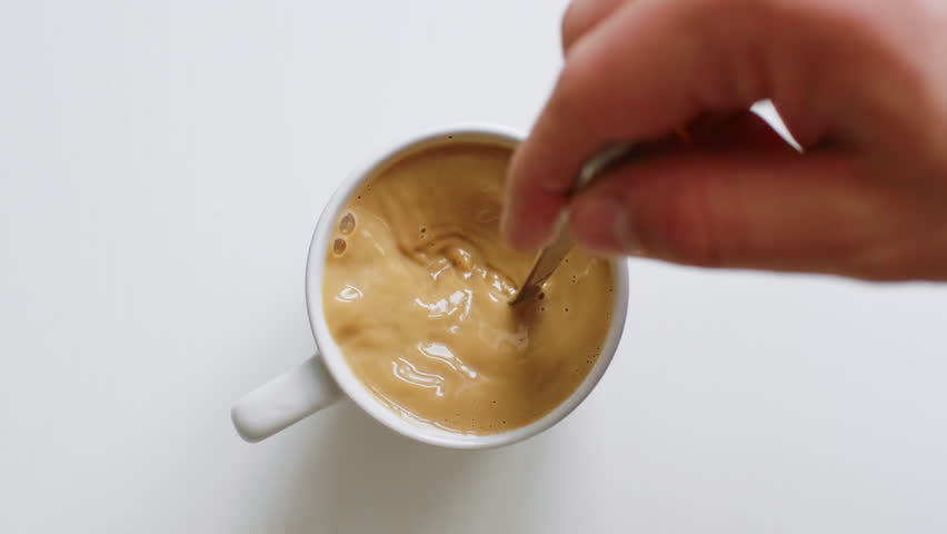 Top view of person hand stirring coffee with spoon | Shutterstock HD Video #1025627474