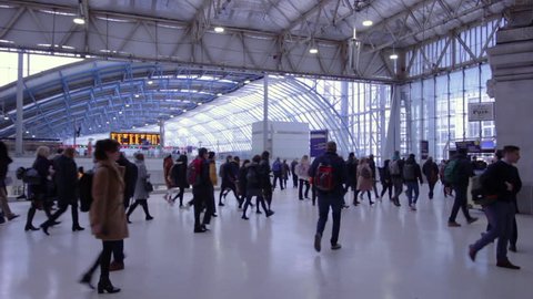 London, England, UK March 12 2019 Commuters at London Waterloo station during the morning rush hour underneath the large glass roof of the historic building