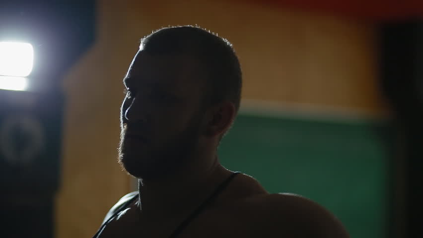 Young white bodybuilder take a rest after exercise breathing deeply.