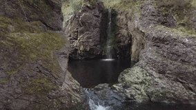 Aerial footage of a small waterfall on the River Foyers, Scottish Highlands, Scotland