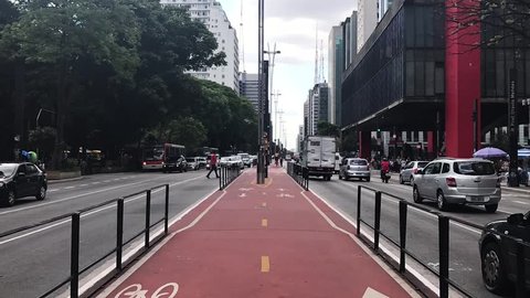 Sao Paulo, Brazil - March 5, 2019: Car traffic at rush hour on Paulista Avenue near MASP and Trianon Park, Sao Paulo city. Time lapse.