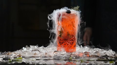 Professional chef and Molecular cuisine. cocktail beverage on black background with liquid nitrogen. Molecular table setting. Slow motion. hd