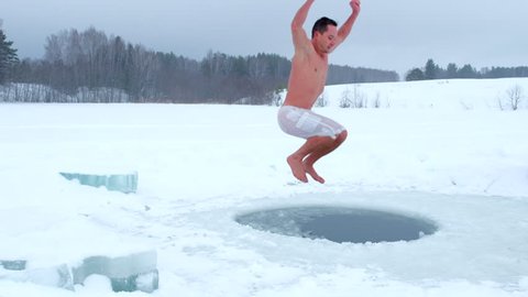 Man jumps into the ice hole