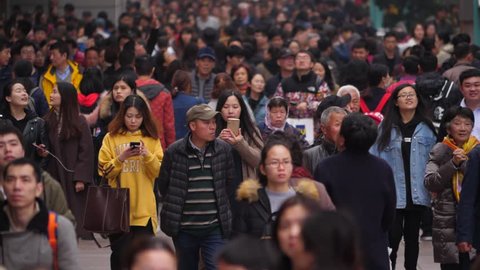 SHANGHAI - MARCH 18, 2018: Pedestrian street crowded with unidentified Chinese people, slow motion shot of Nanjing Road. Different ages, male and female, citizens and domestic tourists walk around