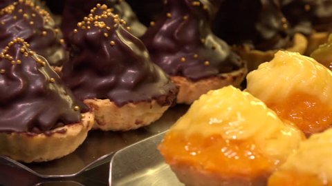 Closeup on fruit and chocolate cupcakes on metallic trays