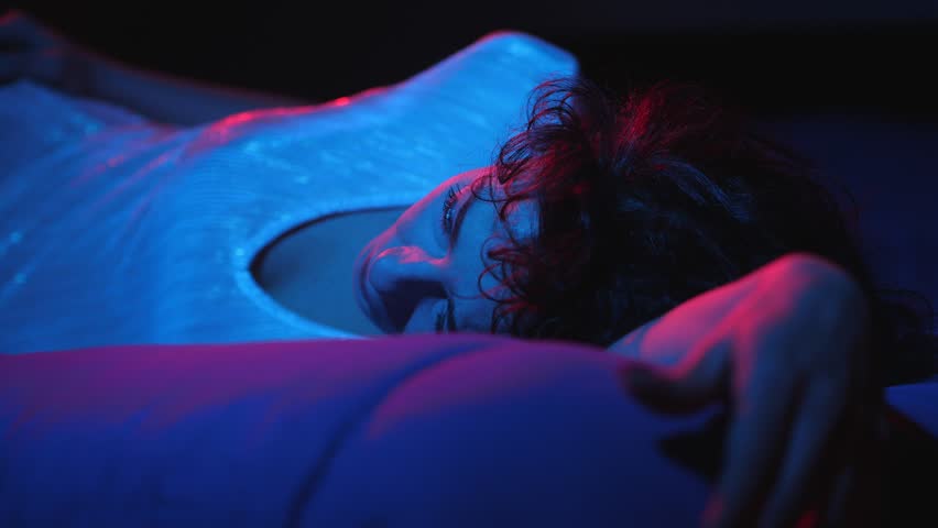 dependence on alchol concept:drunken young woman lying on the bed alone