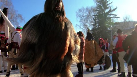 BULGARIA - JANUARY 27, 2019 - Surva masquerade festival on the streets of Pernik, Bulgaria. Kukeri - people dressed in costumes made out of long animal hair and dance to scare the evil spirits.