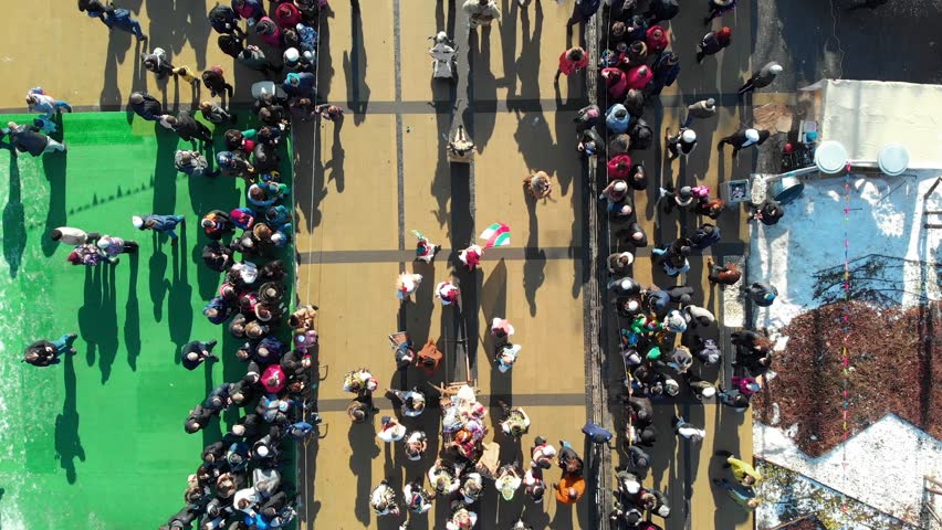BULGARIA - JANUARY 27, 2019 - Aerial view of Surva masquerade festival street in Pernik, Bulgaria. Kukeri - people dressed in costumes and masks dance to scare the evil spirits. | Shutterstock HD Video #1025674712