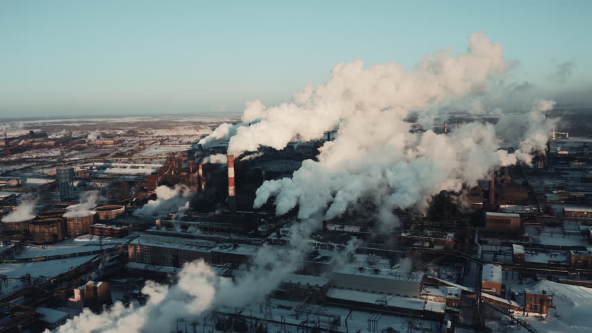 Drone panning of industrial park, many smoke stack pipes of steel plant, technogenic landscape in winter sunny evening, concept of pollution, air emissions from manufacturing sector, industrial city Royalty-Free Stock Footage #1025675324