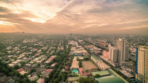 Rising sun in the early morning of the Manila city, Luzon island, Philippines. Misty, foggy sunrise urban suburb background. Aerial view Timelapse 4K