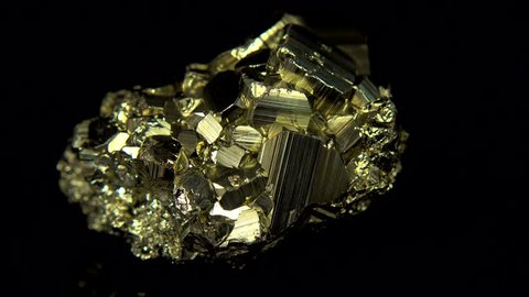 Seamlessly rotating a golden mineral (Pyrite) in front of black background
