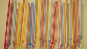 Colorful tubes on yellow background. Stop motion animation video. 