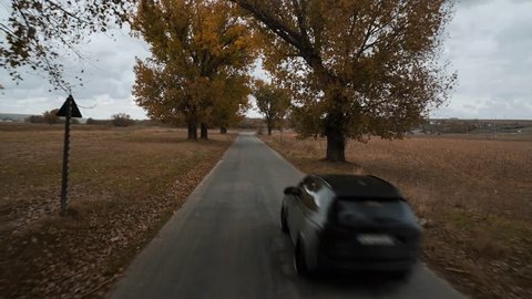 Cheile Dobrogei, Romania-11.11.2017: BMW X5 SUV passing by reveal shot driving on a country side road