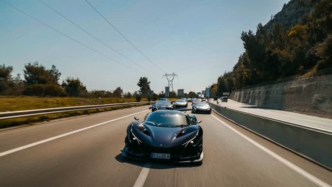 French Riviera, France-04.25.2018: Apollo super car and Lamborghini Hurcan driving on a highway in France at sunset