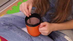 Cute little girl with cup of hot cocoa drink