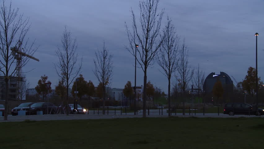 City buildings panorama from park at dawn. Panning.