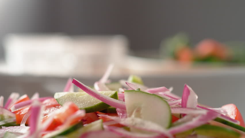 Camera follows putting diced feta cheese over salad. Shot with high speed camera, phantom flex 4K. Slow Motion. Royalty-Free Stock Footage #1025687405