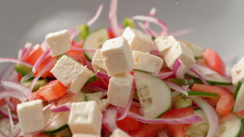 Camera follows putting diced feta cheese over salad. Shot with high speed camera, phantom flex 4K. Slow Motion. Royalty-Free Stock Footage #1025687405