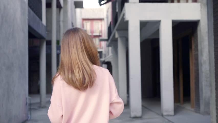 Slow motion - Young Asian blogger woman walking while traveling in the city, beautiful tourist female using smartphone for photo in holidays. Lifestyles woman relax in the city concept.