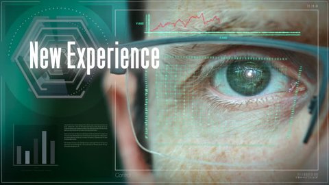 A close up of a businessman eye controlling a futuristic computer system with a New Experience Business concept.