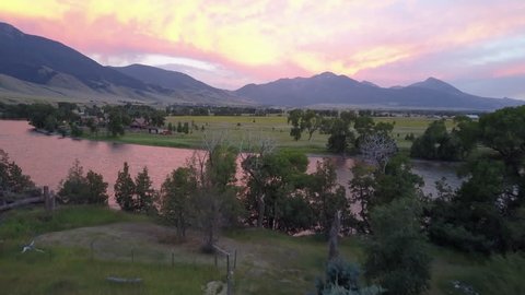 Aerial shot flying over the beautiful Yellowstone River in Paradise Valley at sunset in Montana