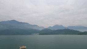 4K video boat movement in the harbor at the lake with mountain view landscape and boat pier of Sun Moon Lake, Nantou, Taiwan