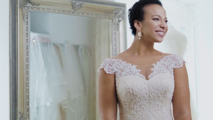 Beautifu bride choosing wedding dress in a wedding salon